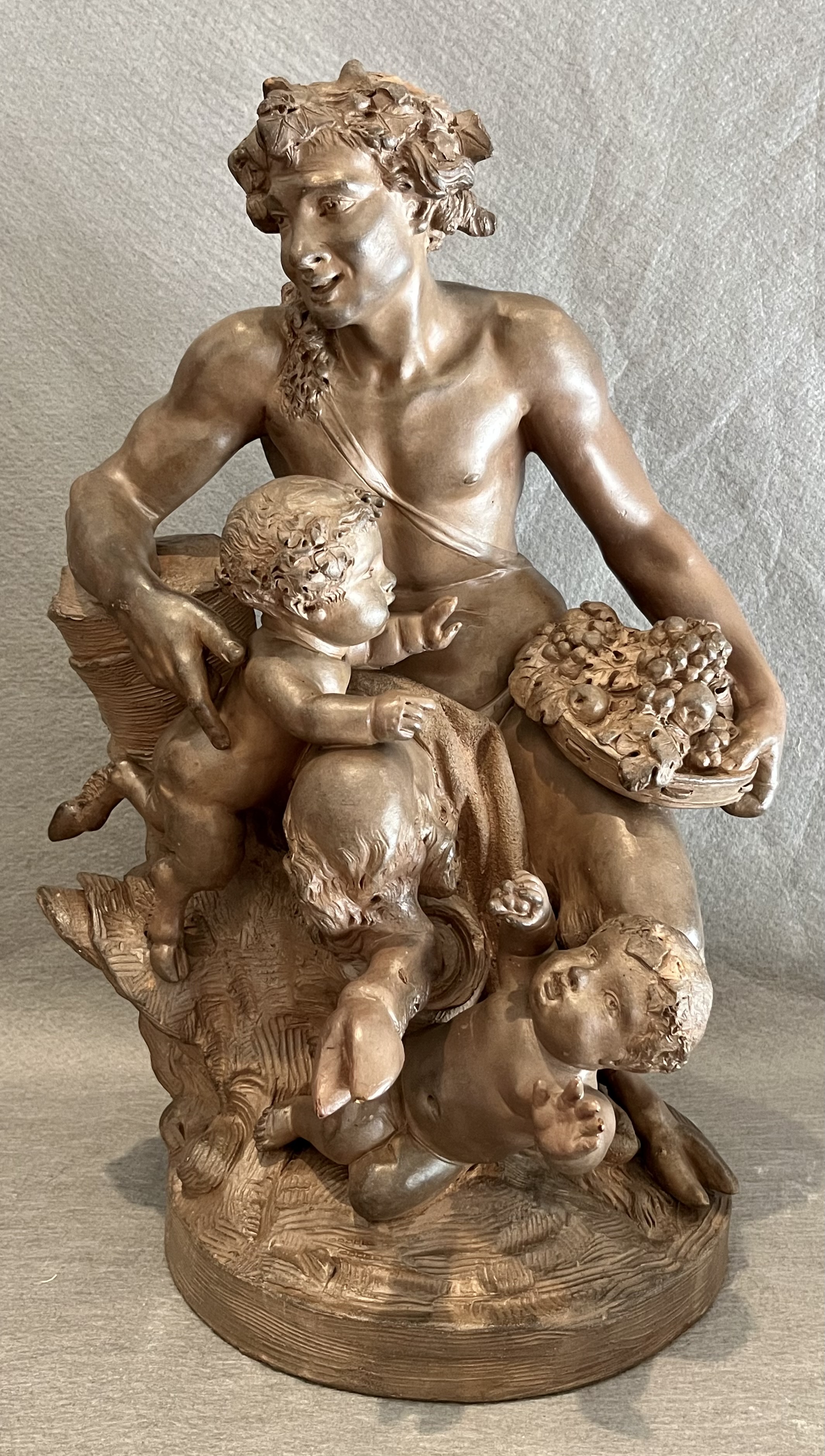 satiro festante con putti e cesto di frutta